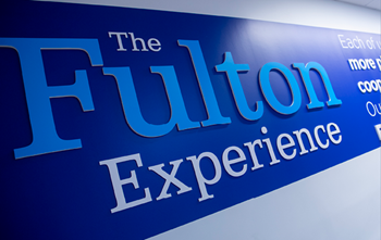 a wall painted with a sign that says the fulton experience