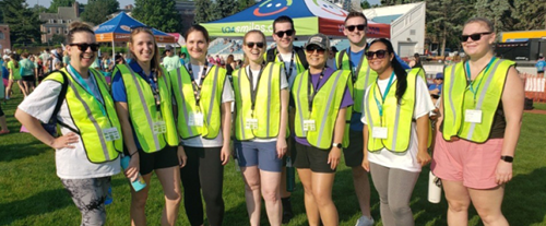 a group of employees volunteering in yellow vests