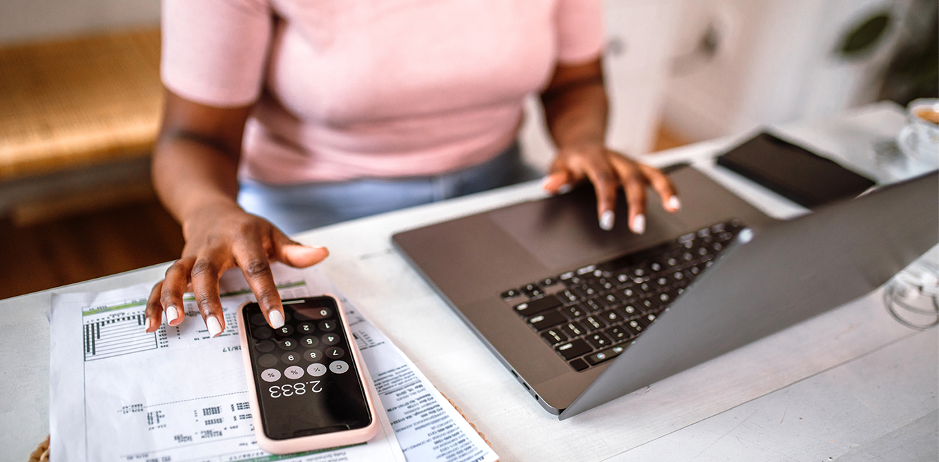 a woman budgeting her with her computer and calculator