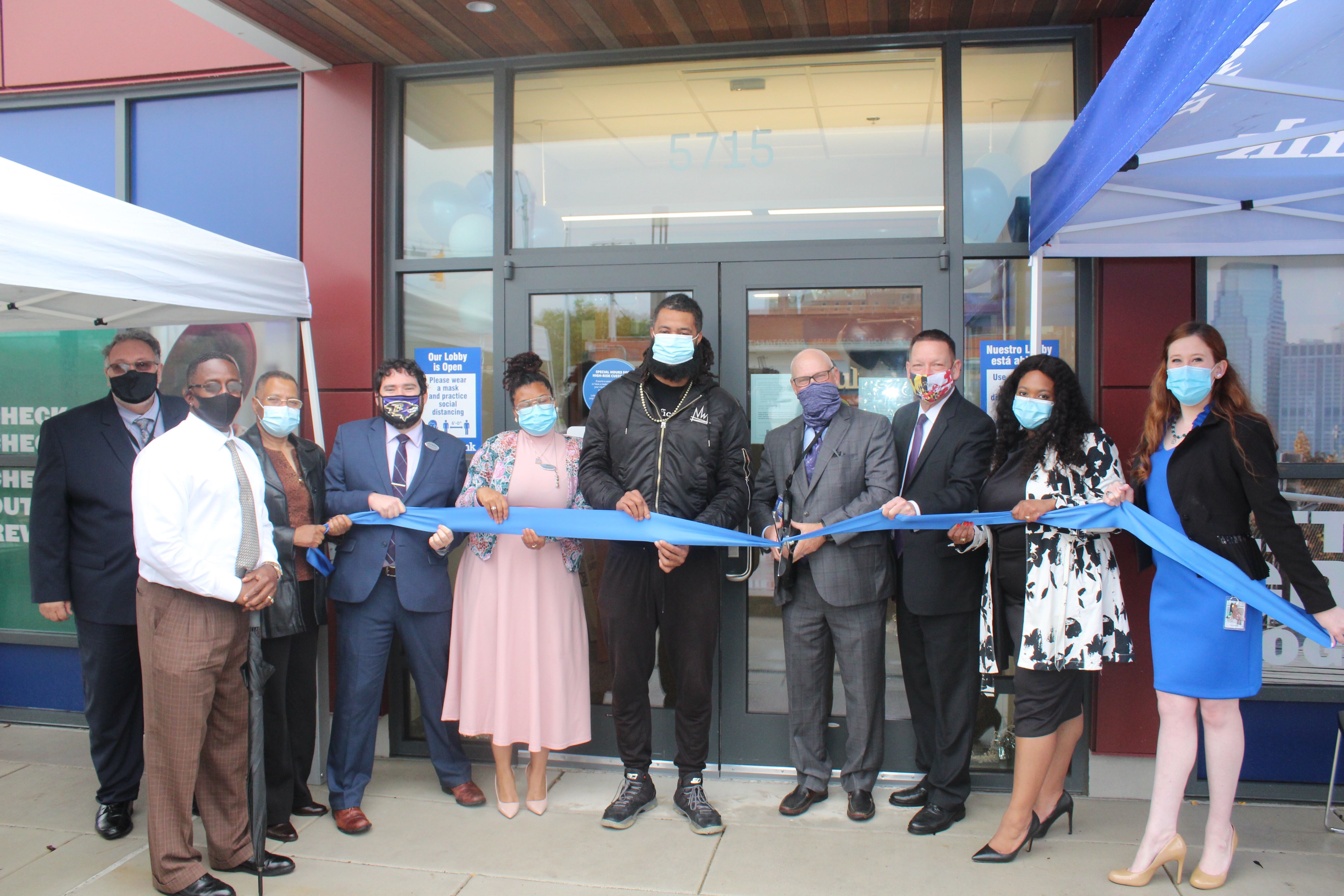Fulton Bank leadership and Baltimore community members cut ribbon in front of new branch